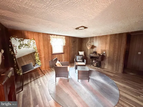 a large bedroom with a bed and a flat tv screen on dresser