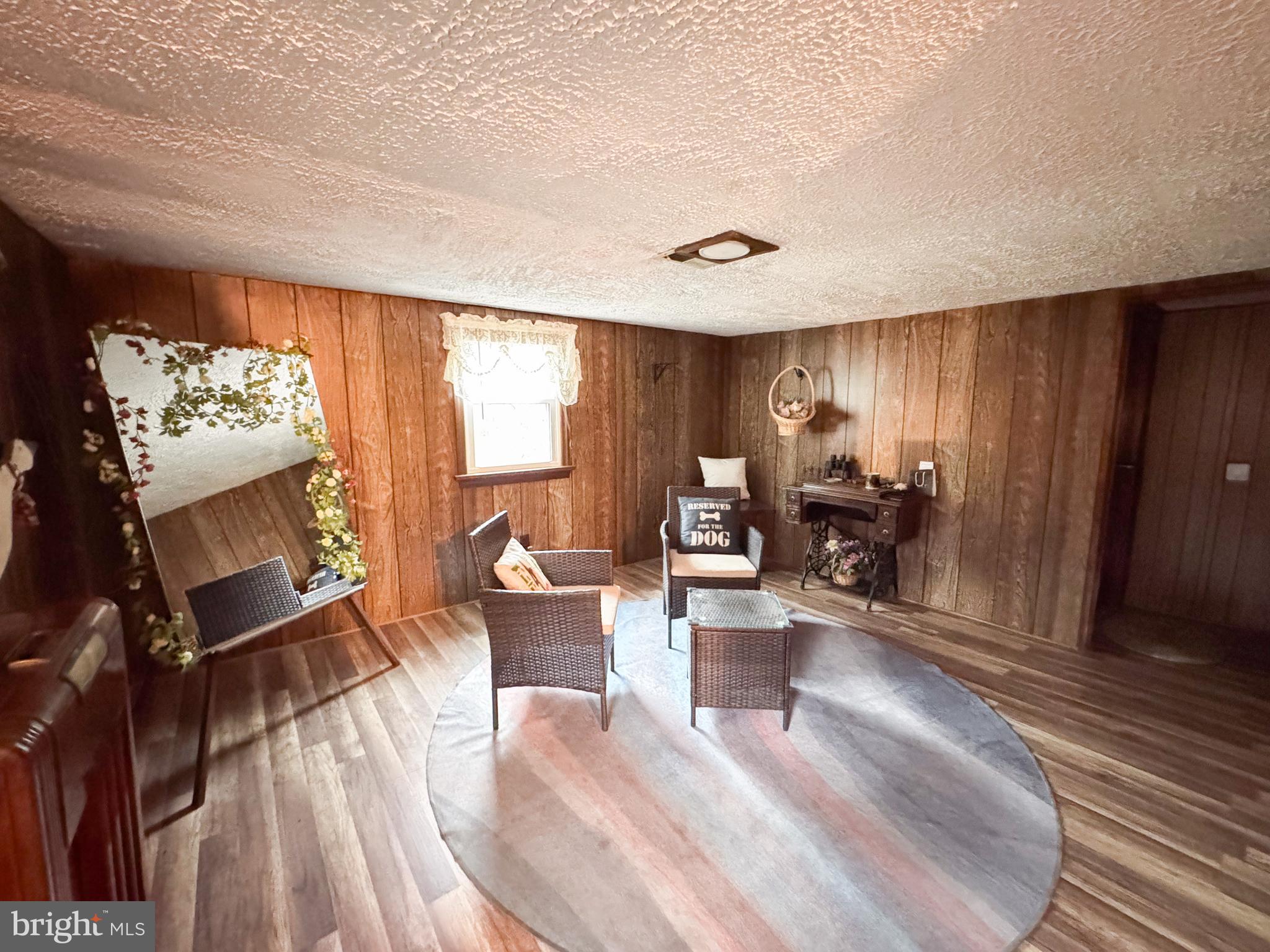 12522 Bakers Hollow Road Hesston, PA 16647 - Photo 20 of 72 a living room with furniture a large window and wooden floor