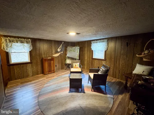 a bed sitting in a spacious bedroom next to a window