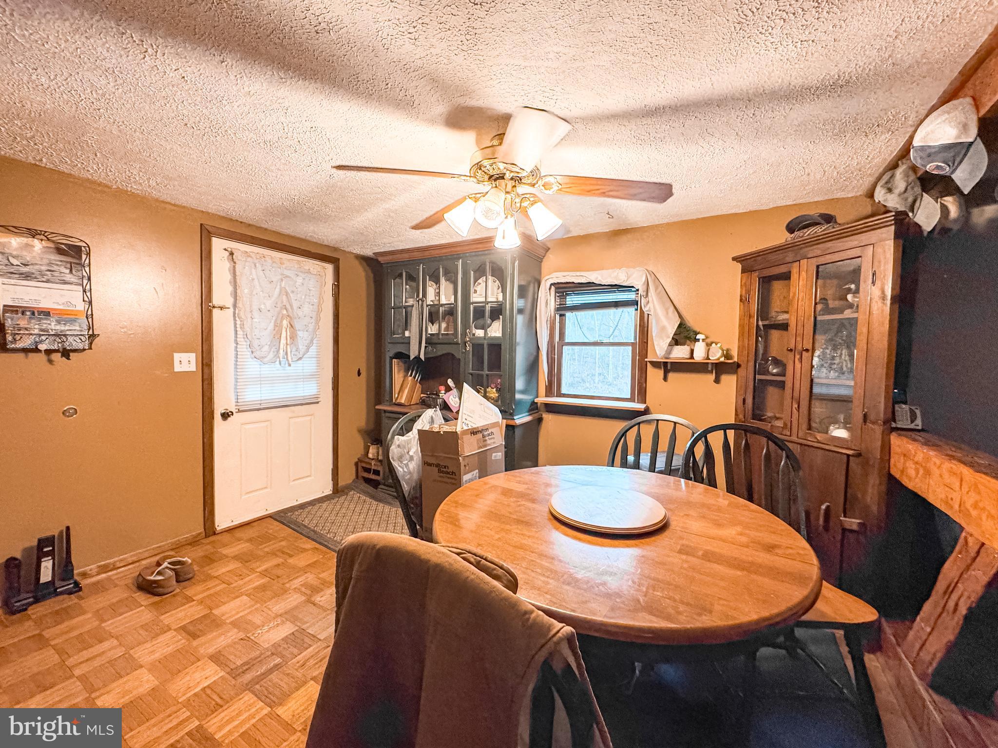 12522 Bakers Hollow Road Hesston, PA 16647 - Photo 47 of 72 a dining room with furniture a large window and a chandelier