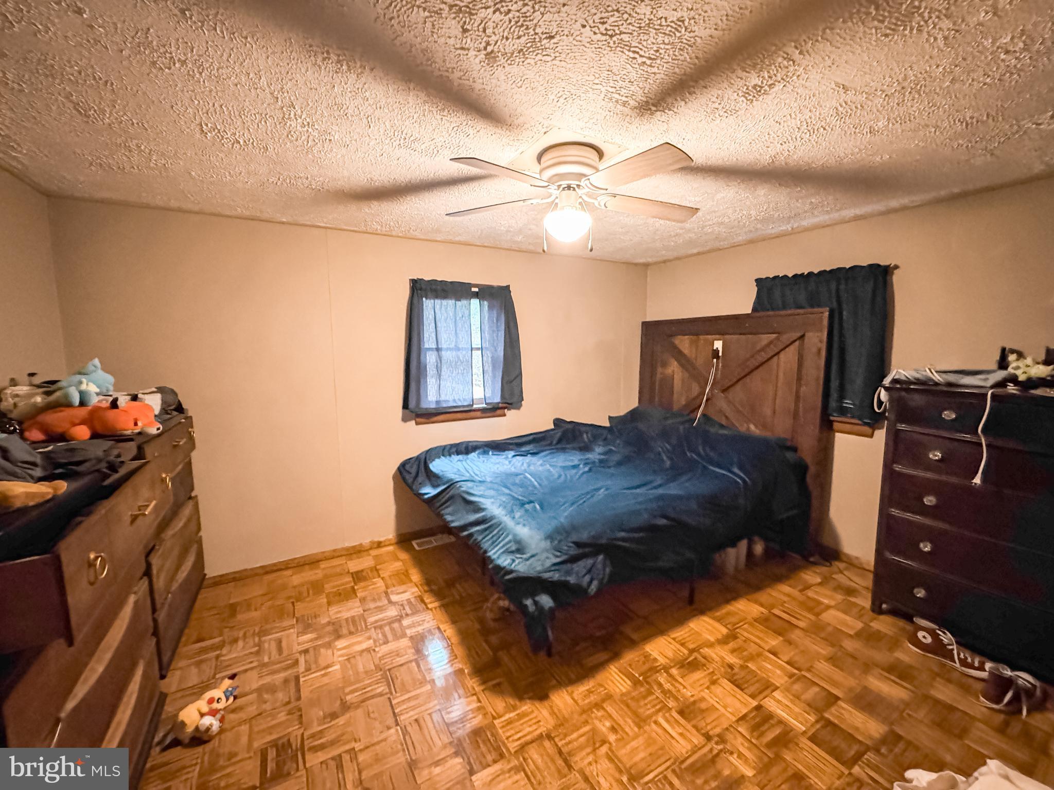 12522 Bakers Hollow Road Hesston, PA 16647 - Photo 53 of 72 a bedroom with a bed and a chandelier