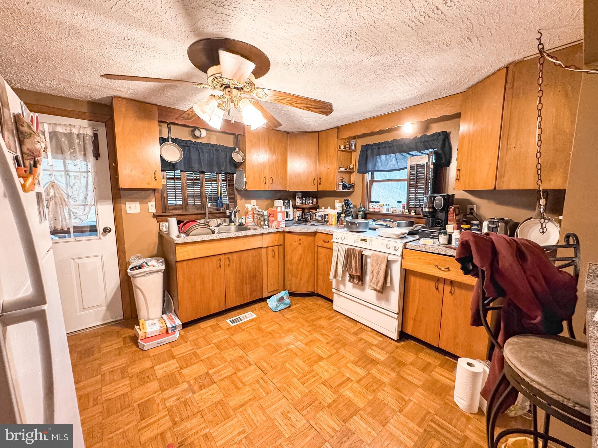 12522 Bakers Hollow Road Hesston, PA 16647 - Photo 54 of 72 a kitchen with stainless steel appliances kitchen island granite countertop a stove a sink dishwasher and white cabinets with wooden floor