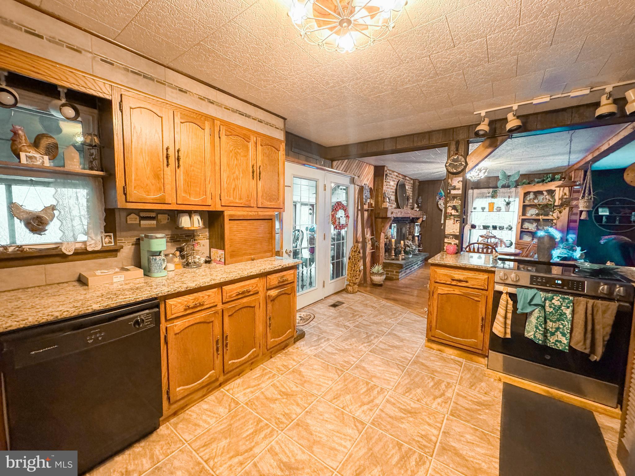 12522 Bakers Hollow Road Hesston, PA 16647 - Photo 6 of 72 a large kitchen with stainless steel appliances granite countertop a sink and cabinets