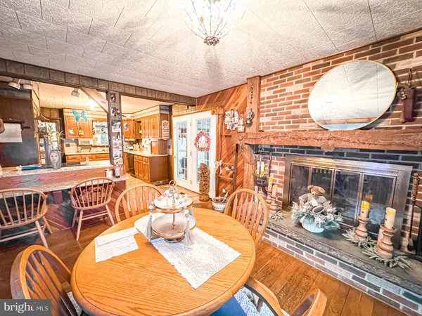 a dining room with furniture and wooden floor