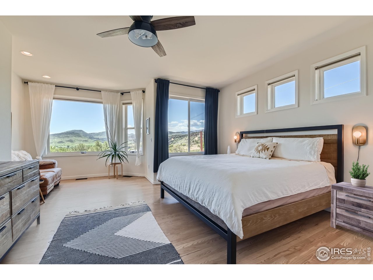 365 Vasquez Court Lyons, CO 80540 - Photo 12 of 40 a bedroom with a large bed and a large window