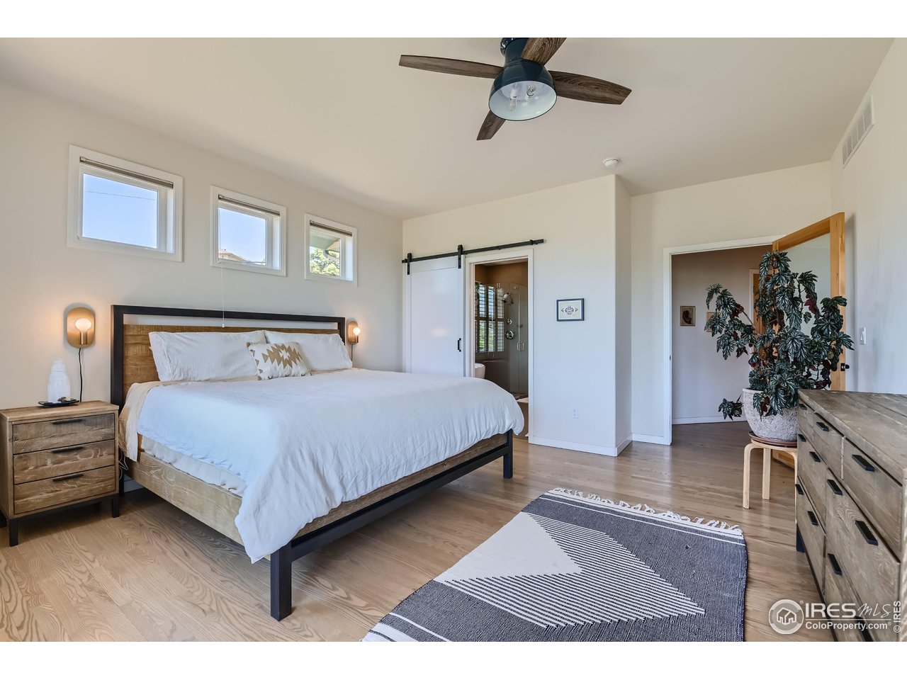 365 Vasquez Court Lyons, CO 80540 - Photo 14 of 40 a bedroom with a bed and a chandelier