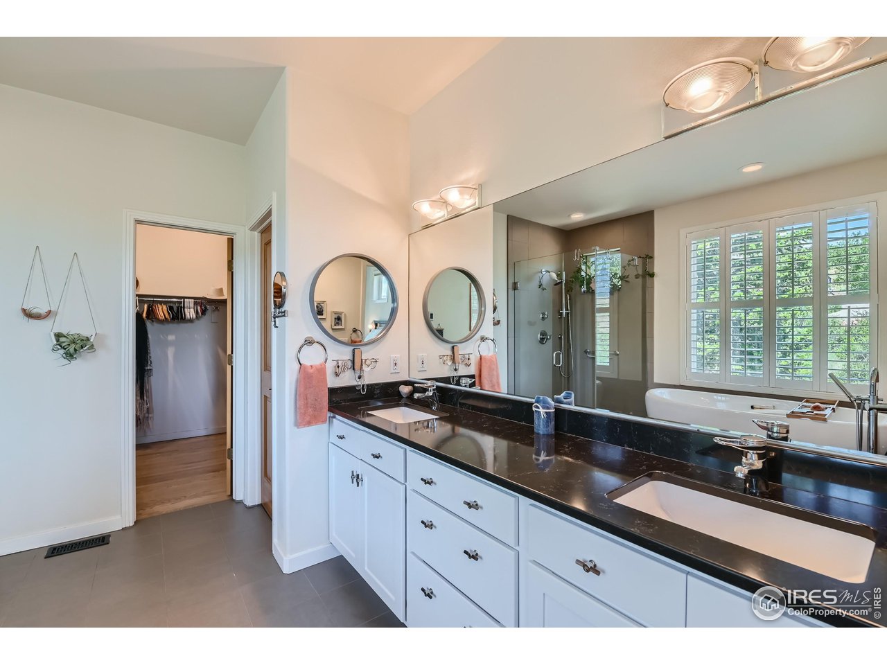 365 Vasquez Court Lyons, CO 80540 - Photo 16 of 40 a large bathroom with a double vanity sink and a mirror