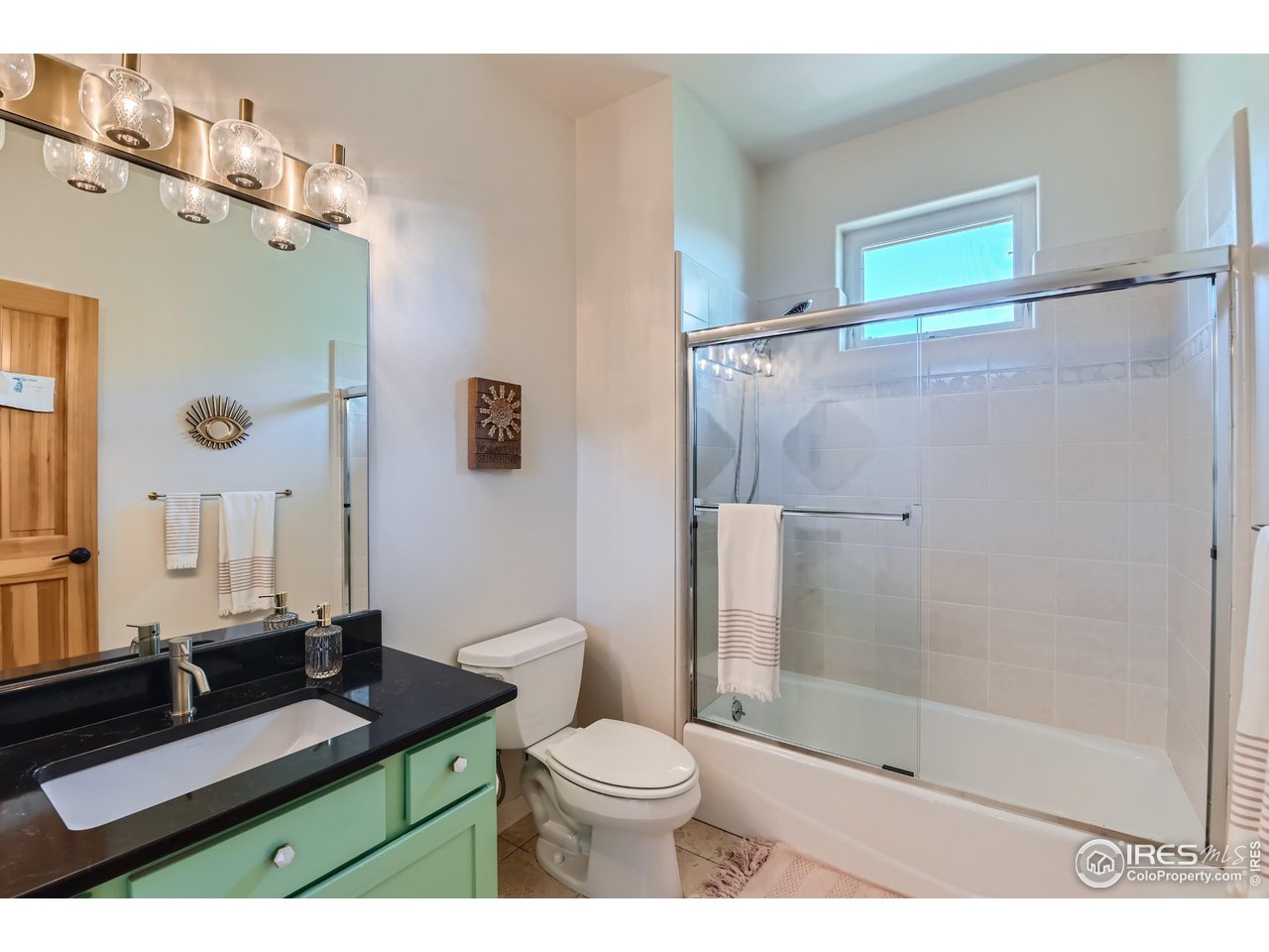 365 Vasquez Court Lyons, CO 80540 - Photo 18 of 40 a bathroom with a granite countertop sink toilet and shower