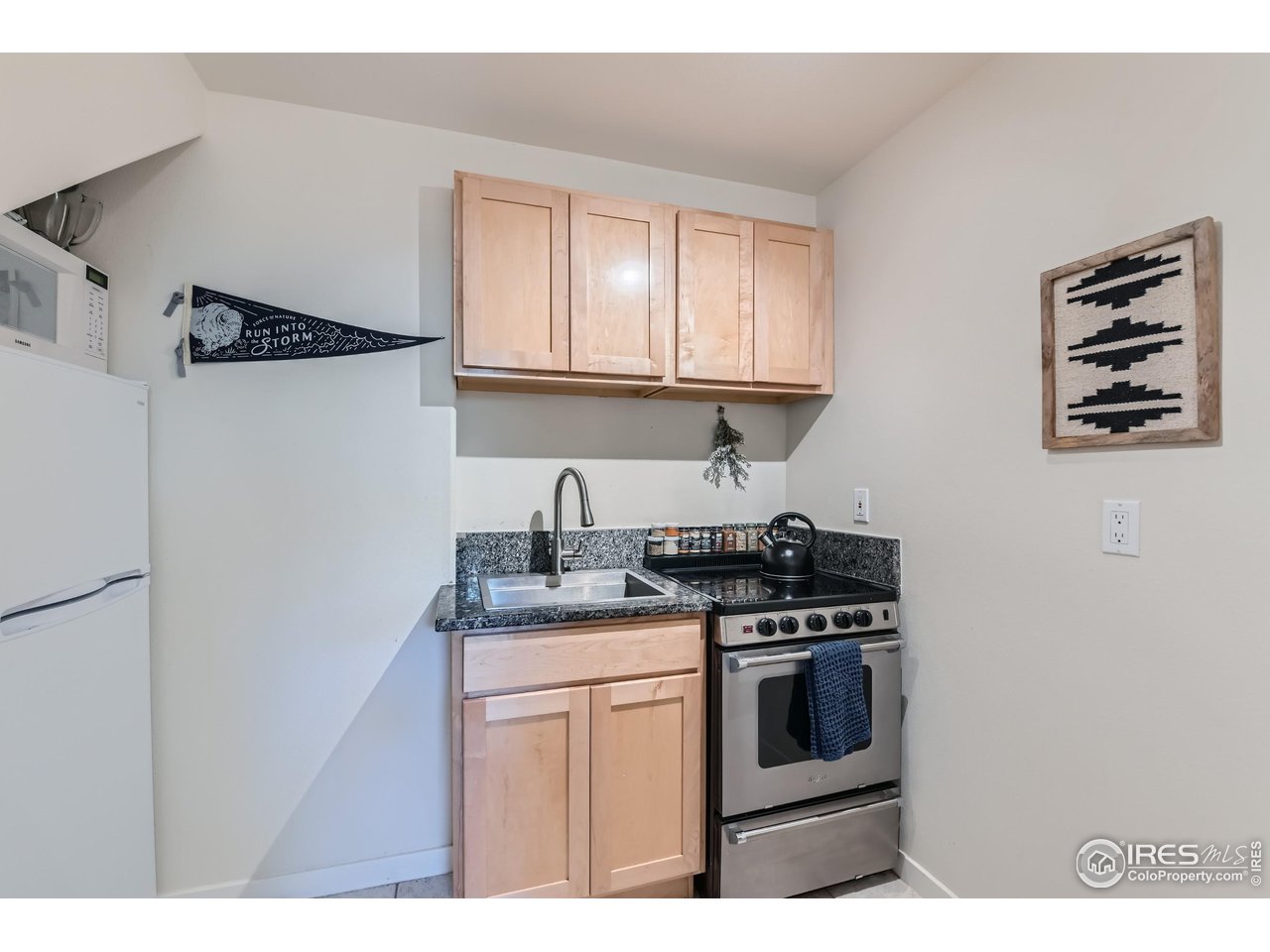 365 Vasquez Court Lyons, CO 80540 - Photo 24 of 40 a kitchen with stainless steel appliances granite countertop a stove a sink and a refrigerator