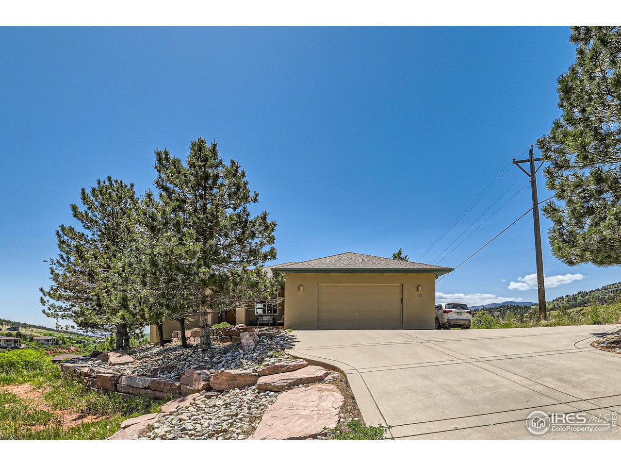 365 Vasquez Court Lyons, CO 80540 - Photo 28 of 40 a front view of a house with a yard and garage