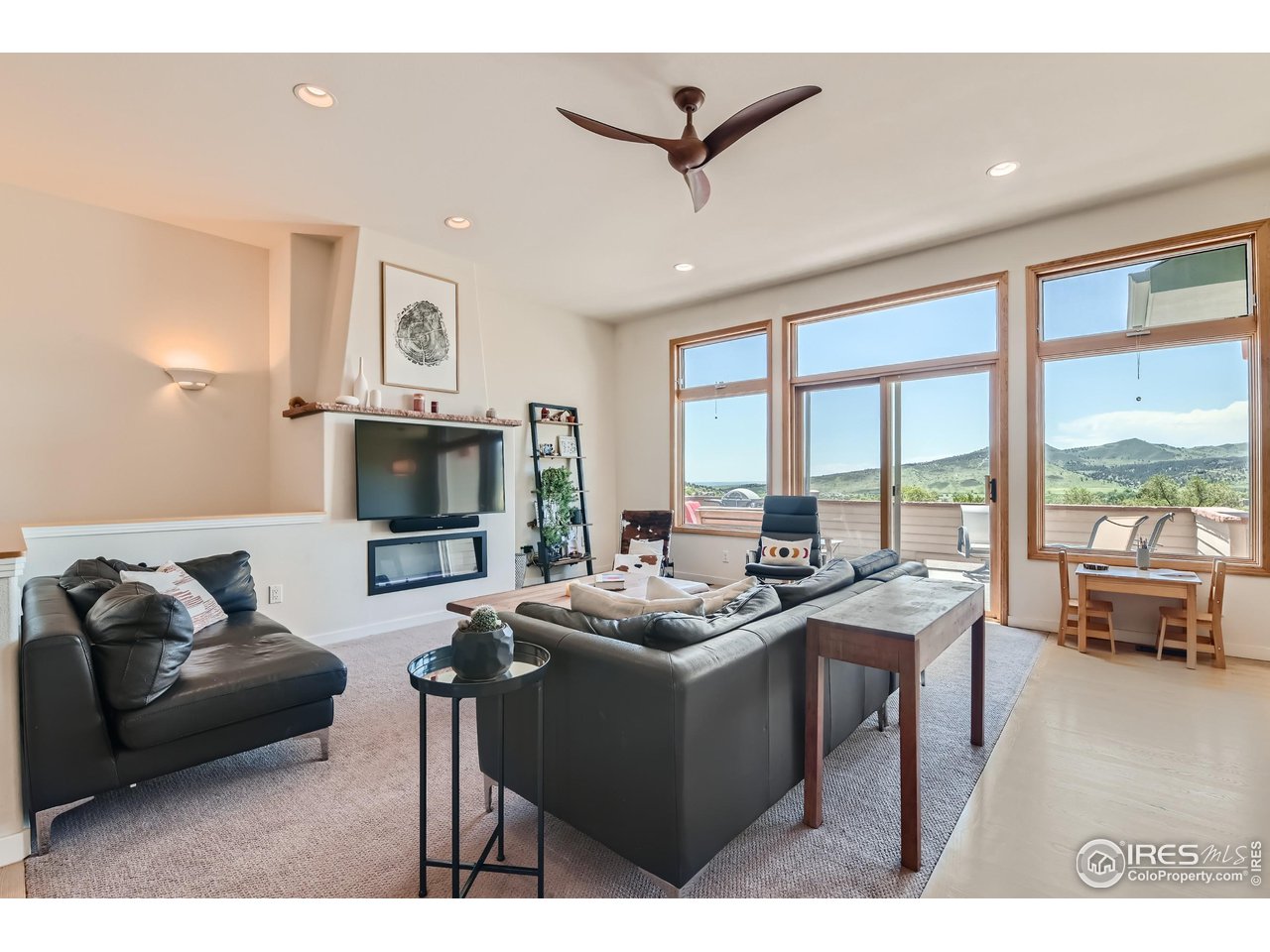 365 Vasquez Court Lyons, CO 80540 - Photo 5 of 40 a living room with furniture a flat screen tv and a large window