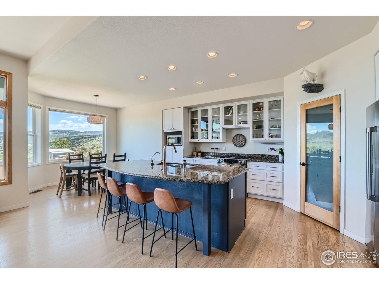 365 Vasquez Court Lyons, CO 80540 - Photo 7 of 40 a kitchen with lots of wooden furniture a sink and dining table