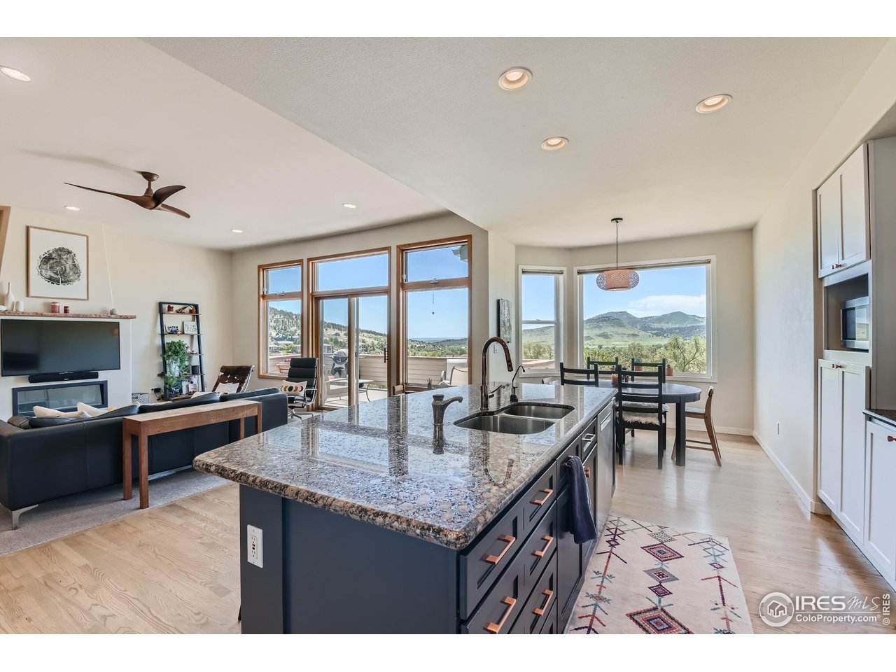 365 Vasquez Court Lyons, CO 80540 - Photo 9 of 40 a dining hall with stainless steel appliances granite countertop a stove and a view of living room