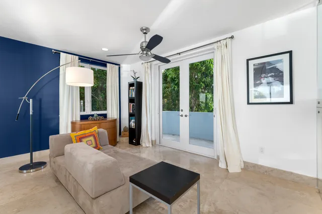 a spacious bedroom with a bed and a chandelier