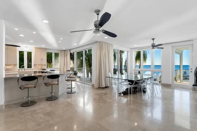 a bedroom with a bed a couch and a chandelier