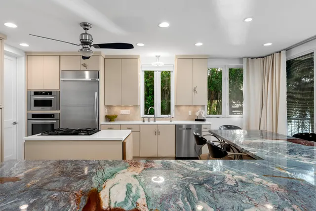 a bedroom with a bed and ceiling fan