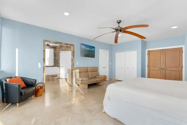 a bedroom with a bed and a large window