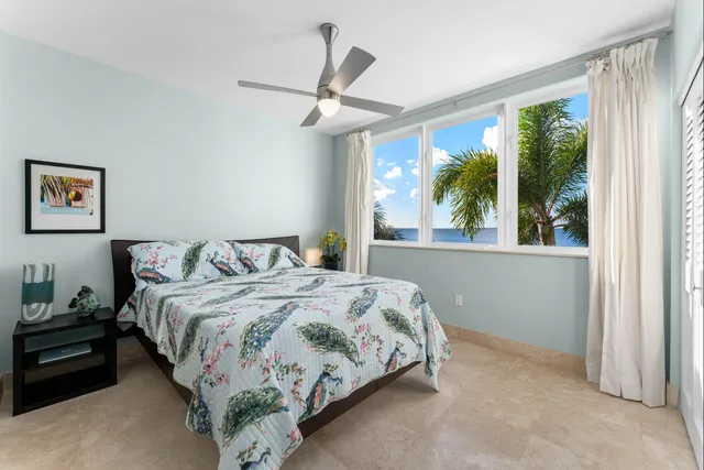 a swimming pool with lawn chairs under an umbrella