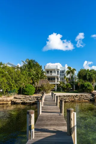 an aerial view of multiple houses with a yard