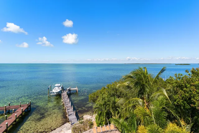 a view of a lake with a table and chairs