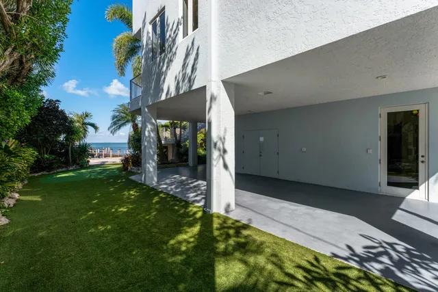a living room with furniture chandelier and a flat screen tv