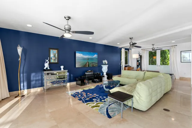 a dining room with lots of furniture and view of kitchen