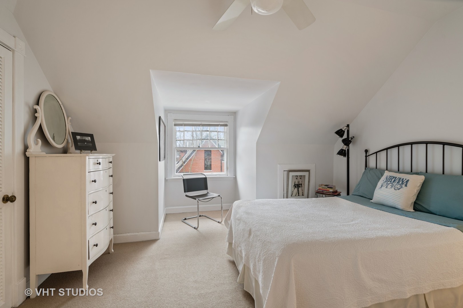 610 Forest Avenue Wilmette, IL 60091 - Photo 22 of 50 a bedroom with a bed and a chandelier
