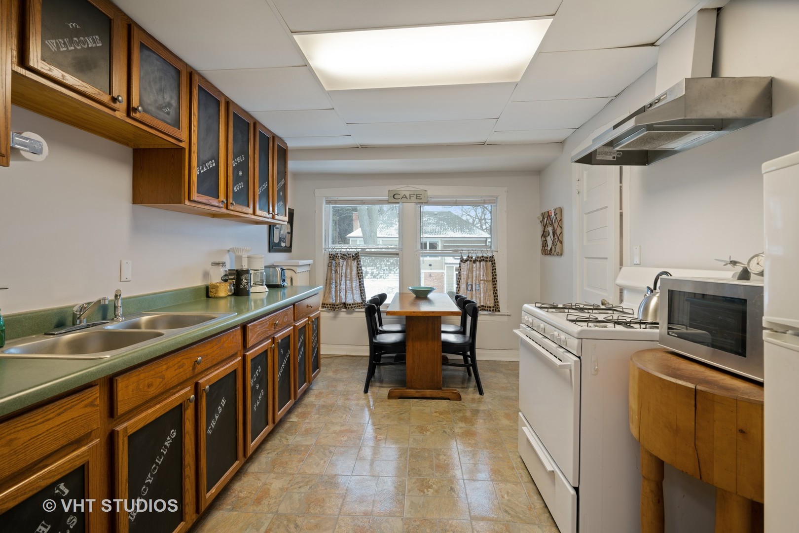 610 Forest Avenue Wilmette, IL 60091 - Photo 29 of 50 a kitchen with stainless steel appliances granite countertop a sink a stove and cabinets