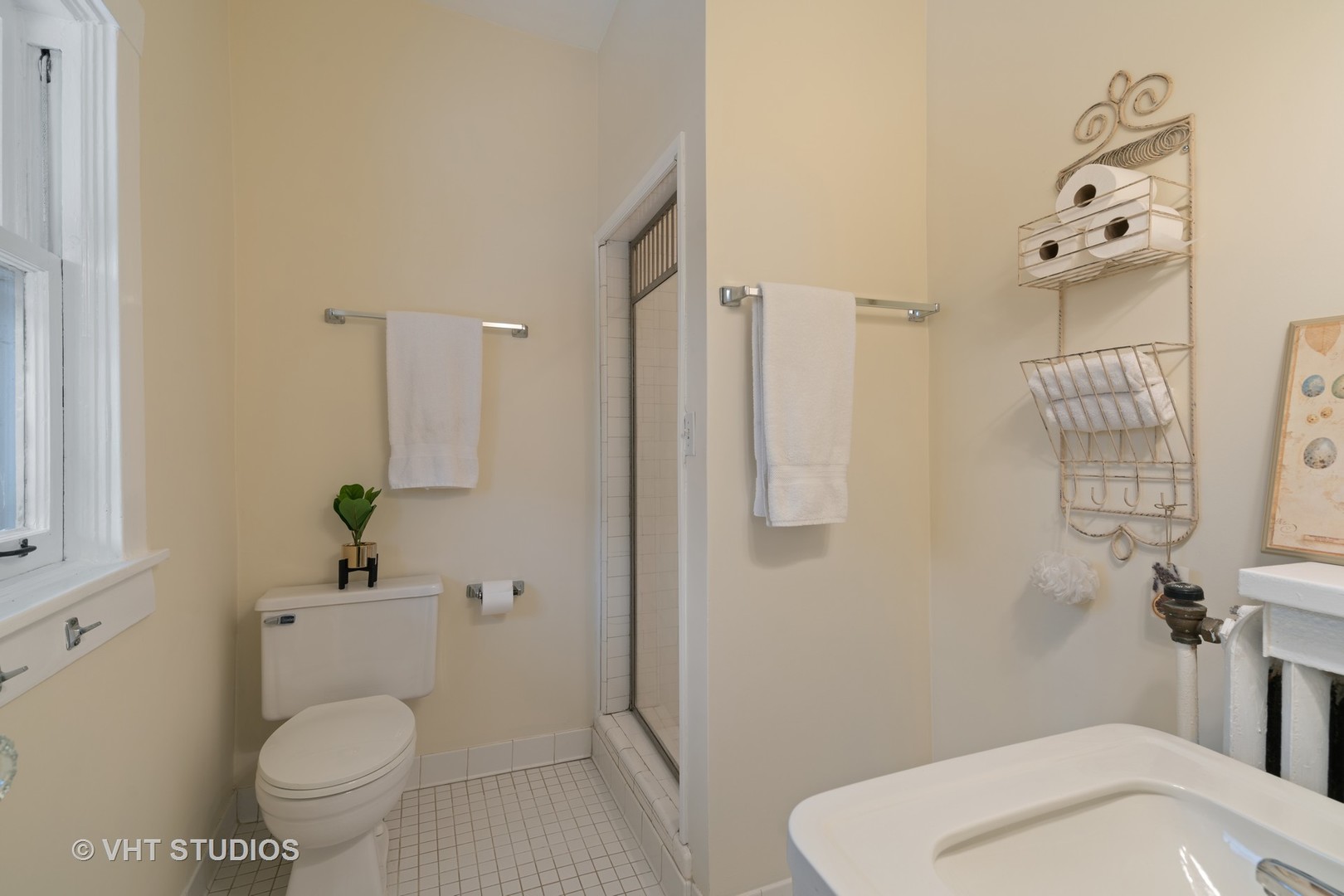 610 Forest Avenue Wilmette, IL 60091 - Photo 38 of 50 a white toilet sitting next to a bathroom sink and a shower