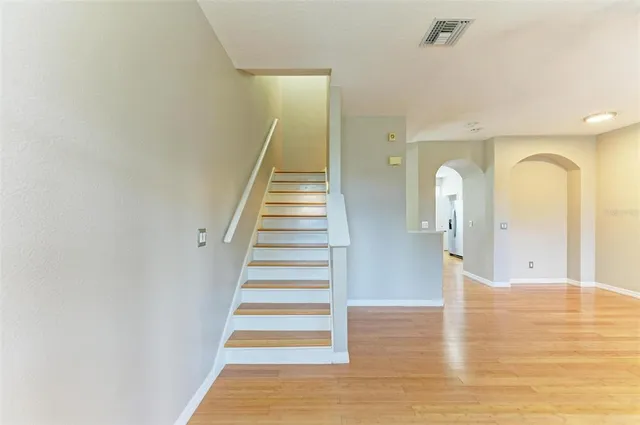 a kitchen with granite countertop a sink a stove and cabinets