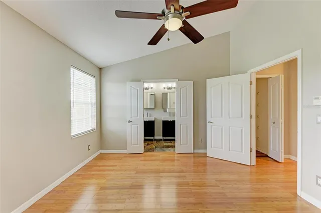 a view of a room with wooden floor and white walls