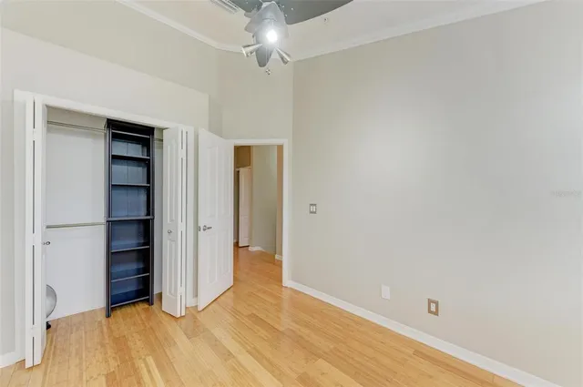 a view of a hallway view with wooden floor and closet
