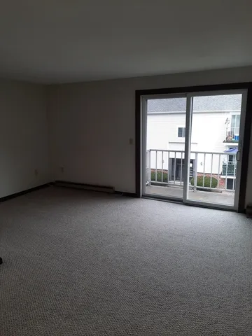 a view of an empty room with a floor to ceiling window