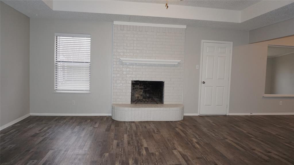 6412 Fairview Drive Watauga, TX 76148 - Photo 2 of 14 a view of an empty room with wooden floor and a window