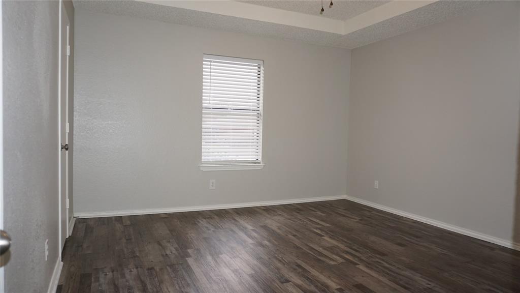 6412 Fairview Drive Watauga, TX 76148 - Photo 6 of 14 an empty room with wooden floor and windows