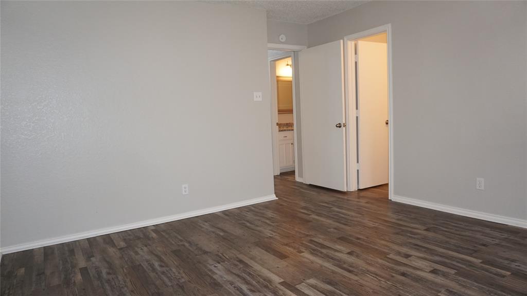 6412 Fairview Drive Watauga, TX 76148 - Photo 7 of 14 a view of an empty room with wooden floor and a window