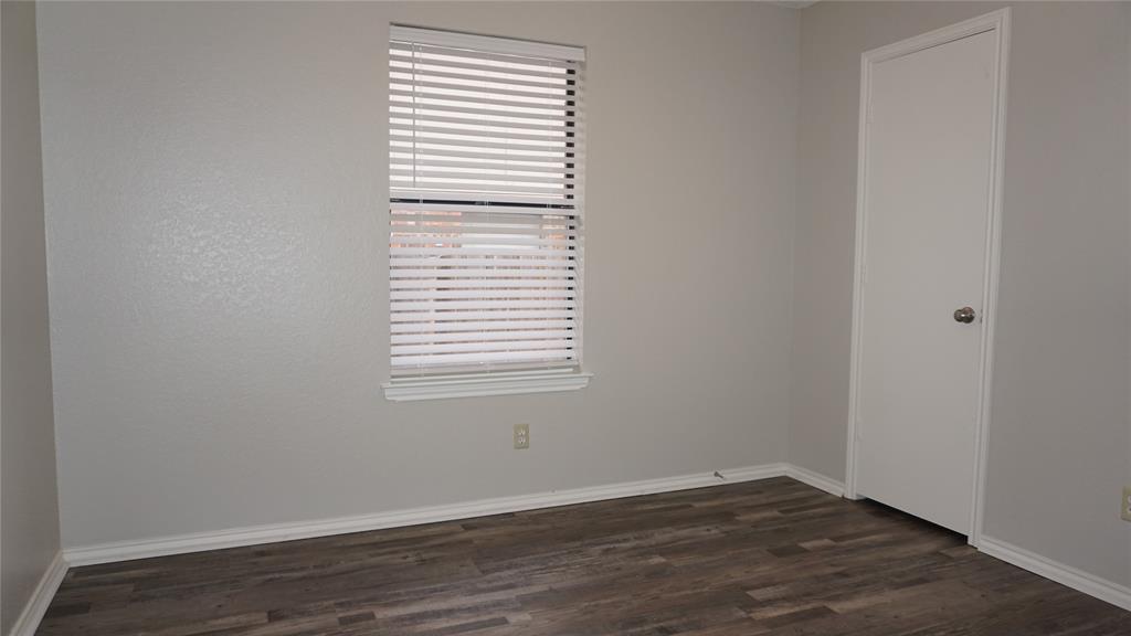 6412 Fairview Drive Watauga, TX 76148 - Photo 9 of 14 an empty room with wooden floor and a window