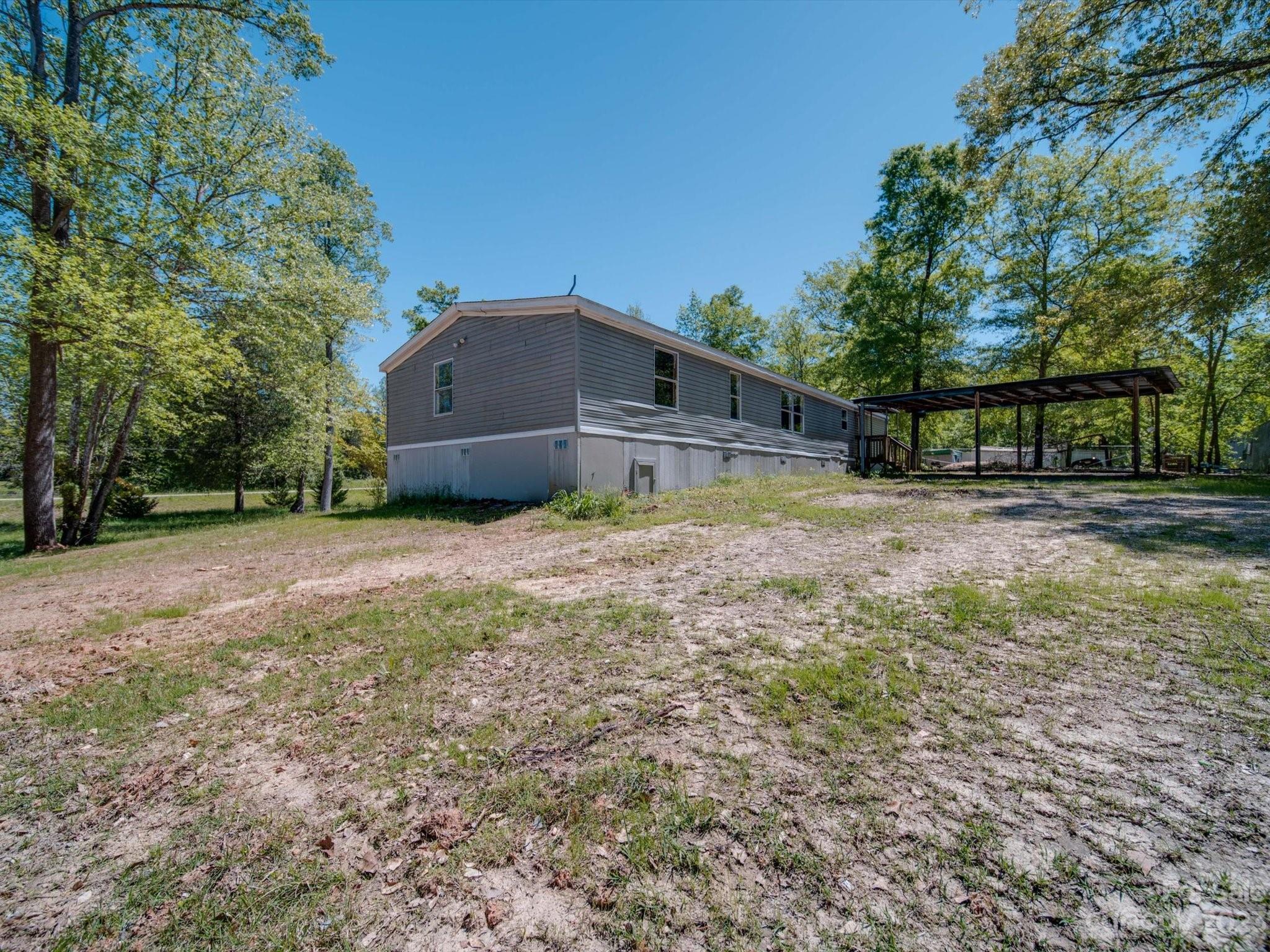 4034 Berry Hill Road Edgemoor, SC 29712 - Photo 29 of 31 a house with trees in front of it
