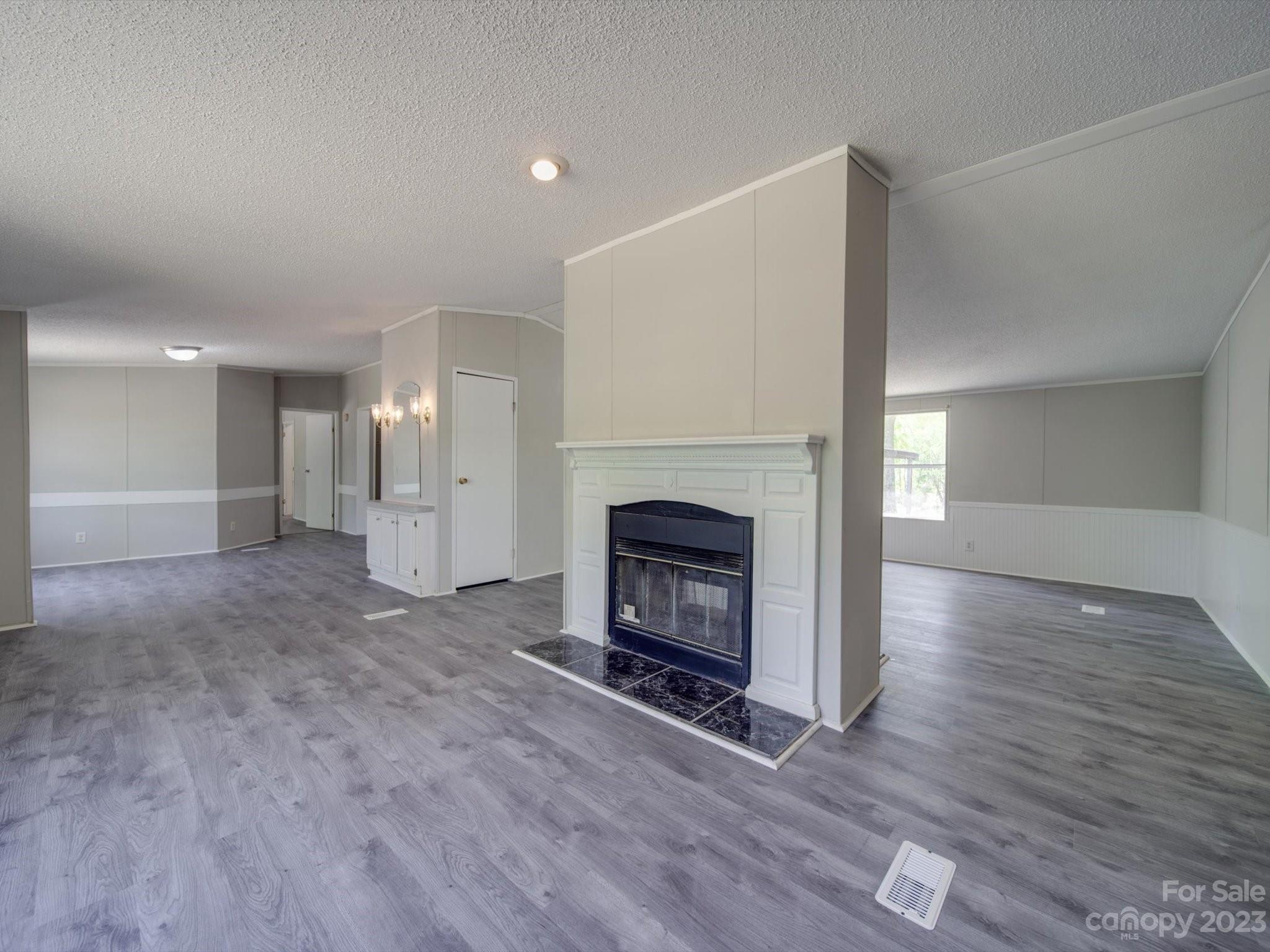 4034 Berry Hill Road Edgemoor, SC 29712 - Photo 7 of 31 a view of a livingroom with a fireplace a fireplace and wooden floor