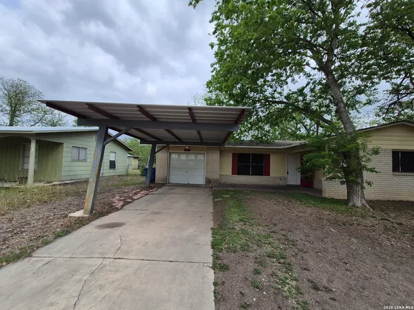 a backyard of a house with table and chairs