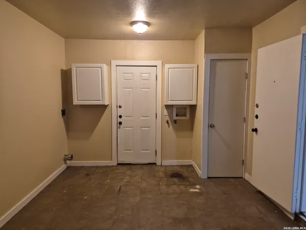 an empty room with wooden floor and closet