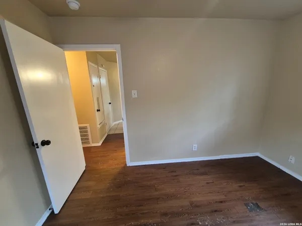 a bathroom with a granite countertop shower and a toilet