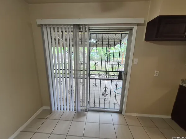 a view of an empty room and window chandelier fan