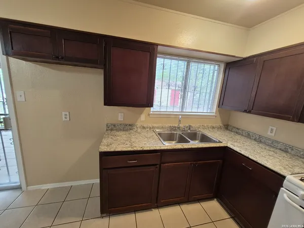 a kitchen with a stove sink and cabinets
