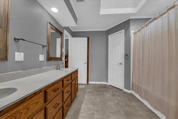 a spacious bathroom with a double vanity sink and a mirror