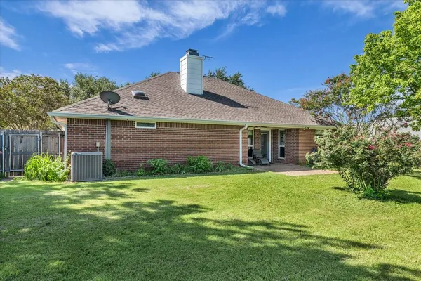 a backyard of a house with yard and outdoor seating