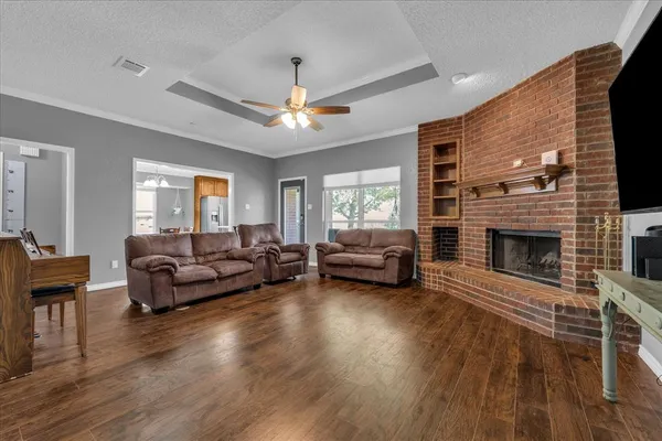 a living room with furniture a fireplace and a flat screen tv