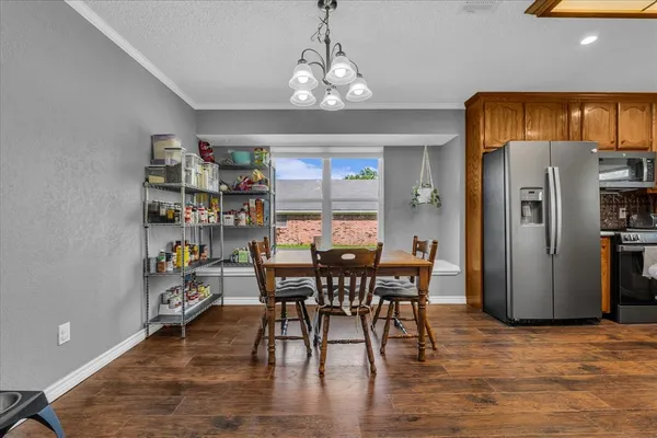 a view of a dining room with furniture and wooden floor