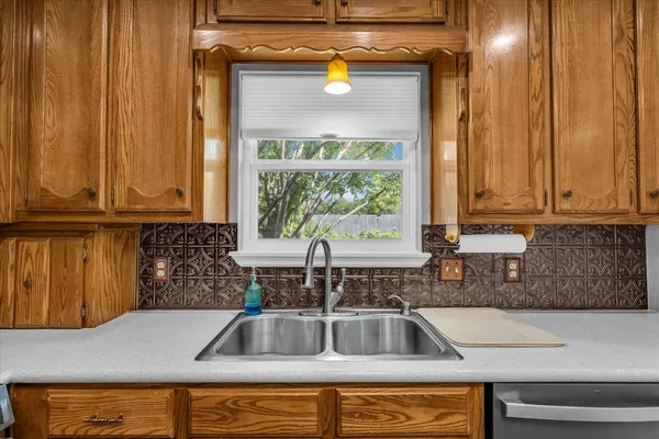 a kitchen with a sink and a window