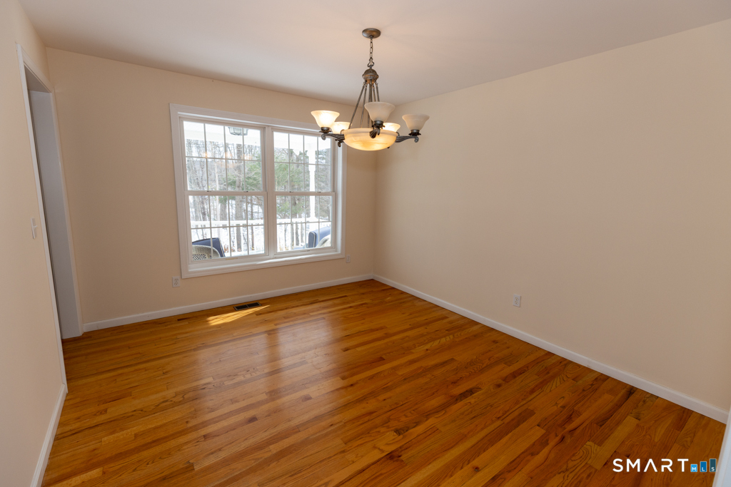 85 McVeagh Road Westbrook, CT 06498 - Photo 15 of 39 a view of empty room with wooden floor and fan